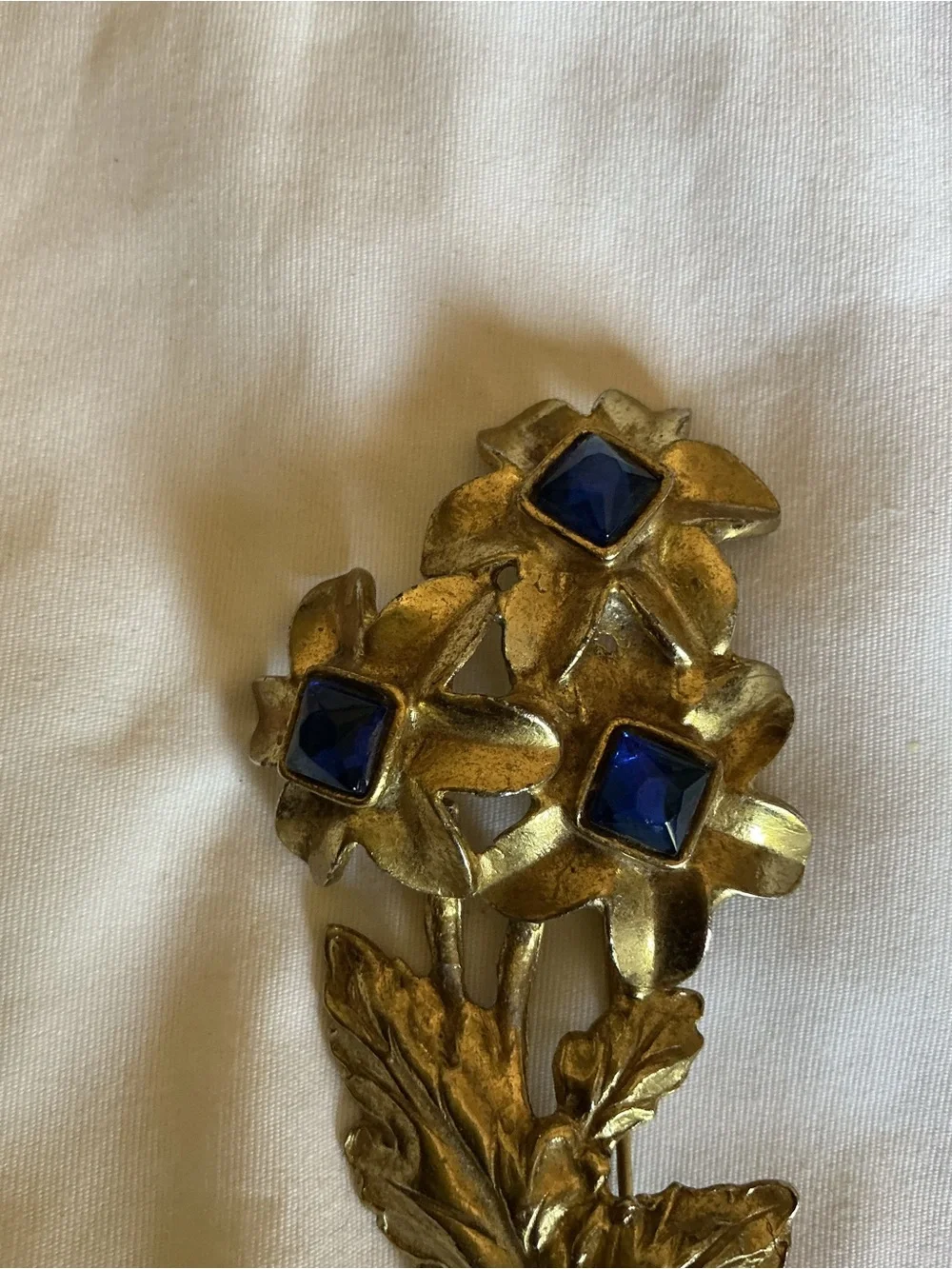 Gold Tone Floral Brooch with Blue Glass Stones